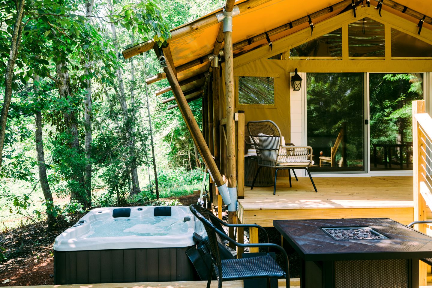 Shangri La deck with hot tub and fire pit table in golden light